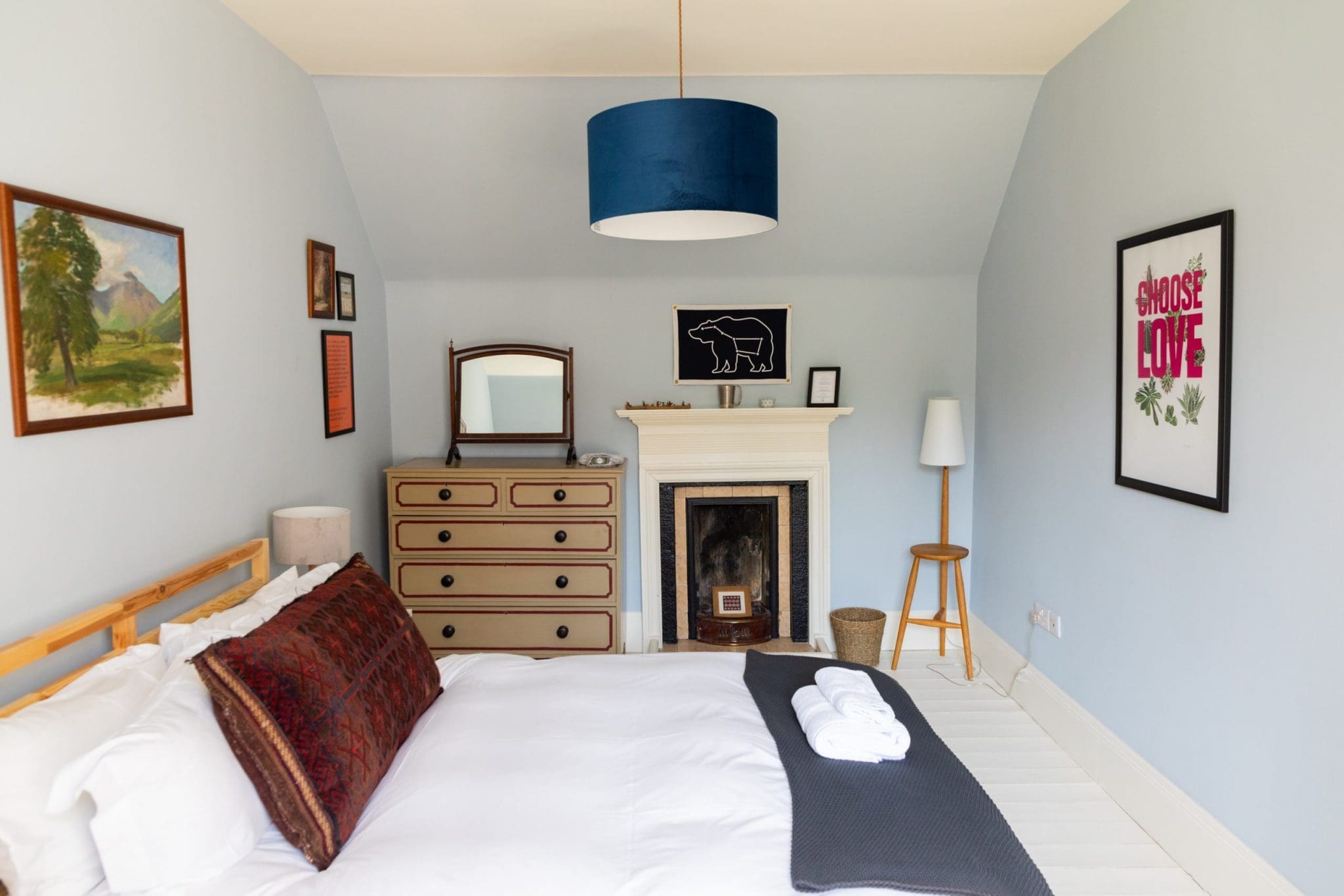 Photo taken of the bedroom interior of the North Lodge Cabin. Showcasing its bright colours, and cosy furnishings.