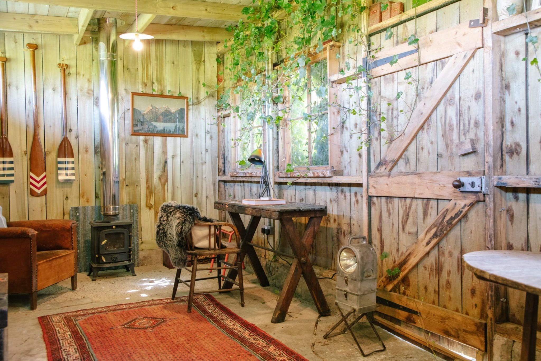 A snap of the cosy and warm furnishing of the Cuttieshillock Cottage with its wooden walls and natural flooring and rustic furniture.