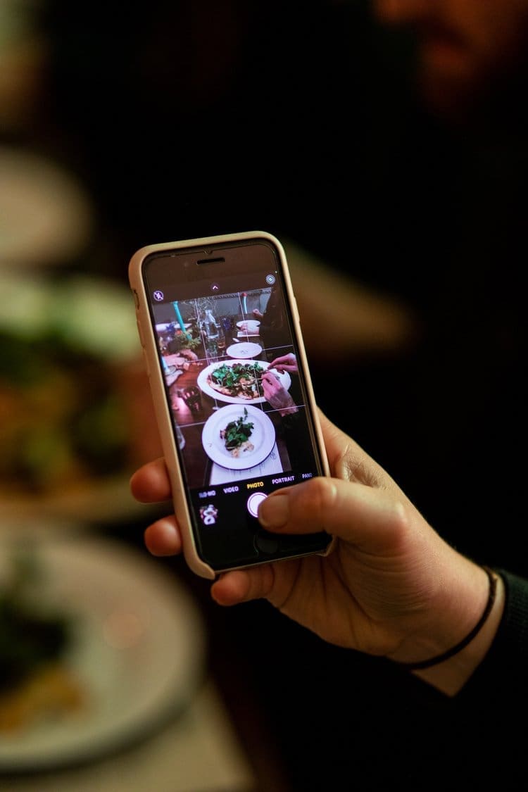 A snap of a guest taking a picture of their dinner plate at our seasonal feast event
