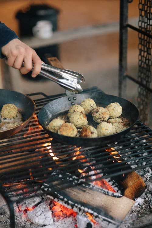 Food being prepared outdoors on a grill ready for one of our seasonal feast events