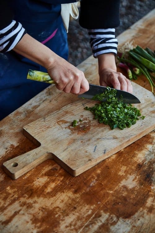 Our winter Chef Pippy cutting spring onions ready for the seasonal feast