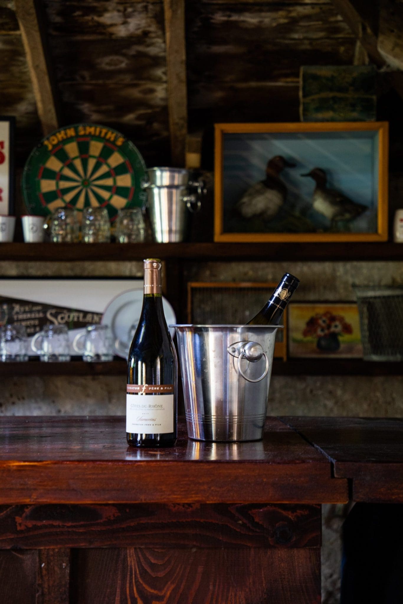 2 bottles of champagne, one in an ice bucket on top of the bar in the Glen Dye Arms