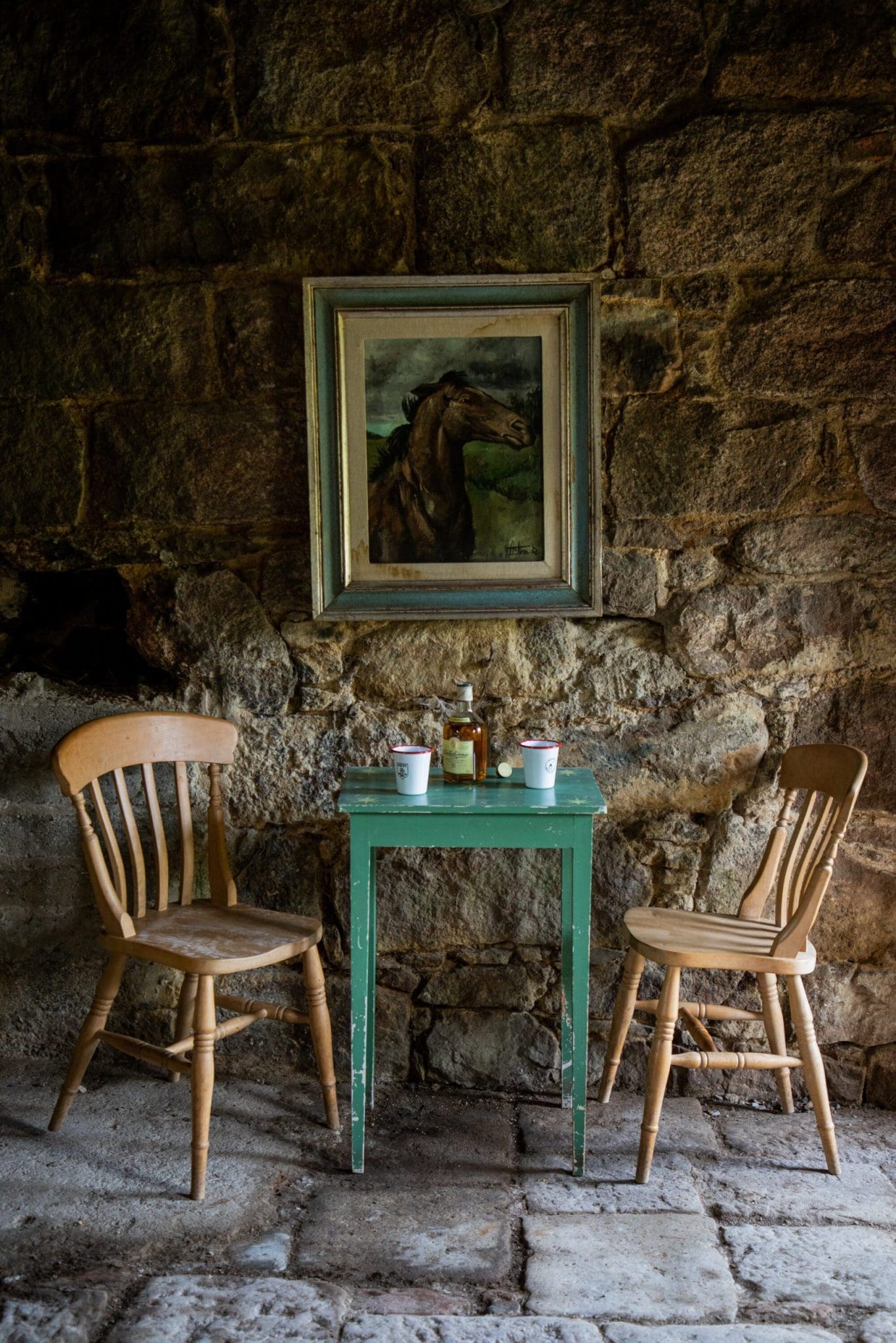 A table and chairs in a stone bricked building