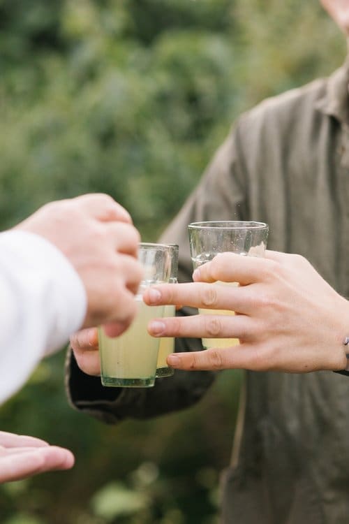 Close up image of an individual giving out drinks at the Taigh music event